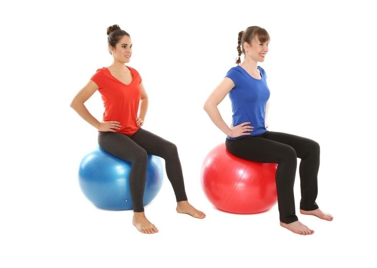 Two Women Exercising On Stability Ball